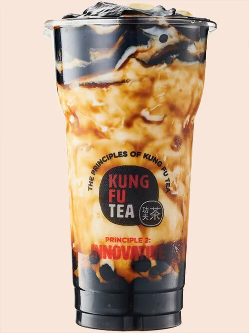 Iced Kung Fu Tea milk tea in a branded clear cup, topped with dark herbal jelly.